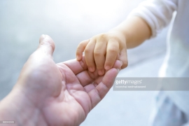 holding baby hand