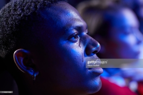 Side view of man crying while watching movie